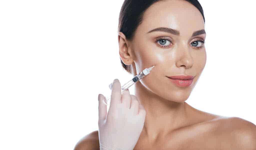 A woman getting dermal fillers in her cheeks