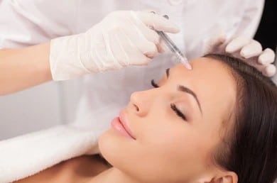 A woman getting BOTOX in her forehead