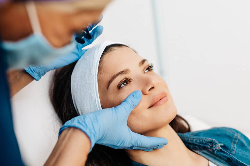 Facial aesthetics surgery treatment Provider performing an aesthetic facial assessment before treatment at Timeless Youth MD in West Des Moines